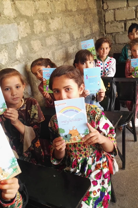 Girls reading ABLE books in a classroom